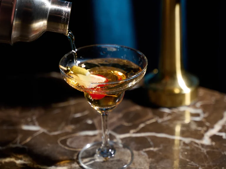 Elegant drink bar at Tara Bangkok featuring a wide selection of premium spirits, wines, and cocktails, offering diverse alcohol choices in a refined lounge setting.